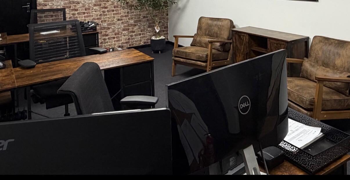 LC Vending Solutions meeting room in Basildon — wood-clad accent wall, plants and a water cooler.