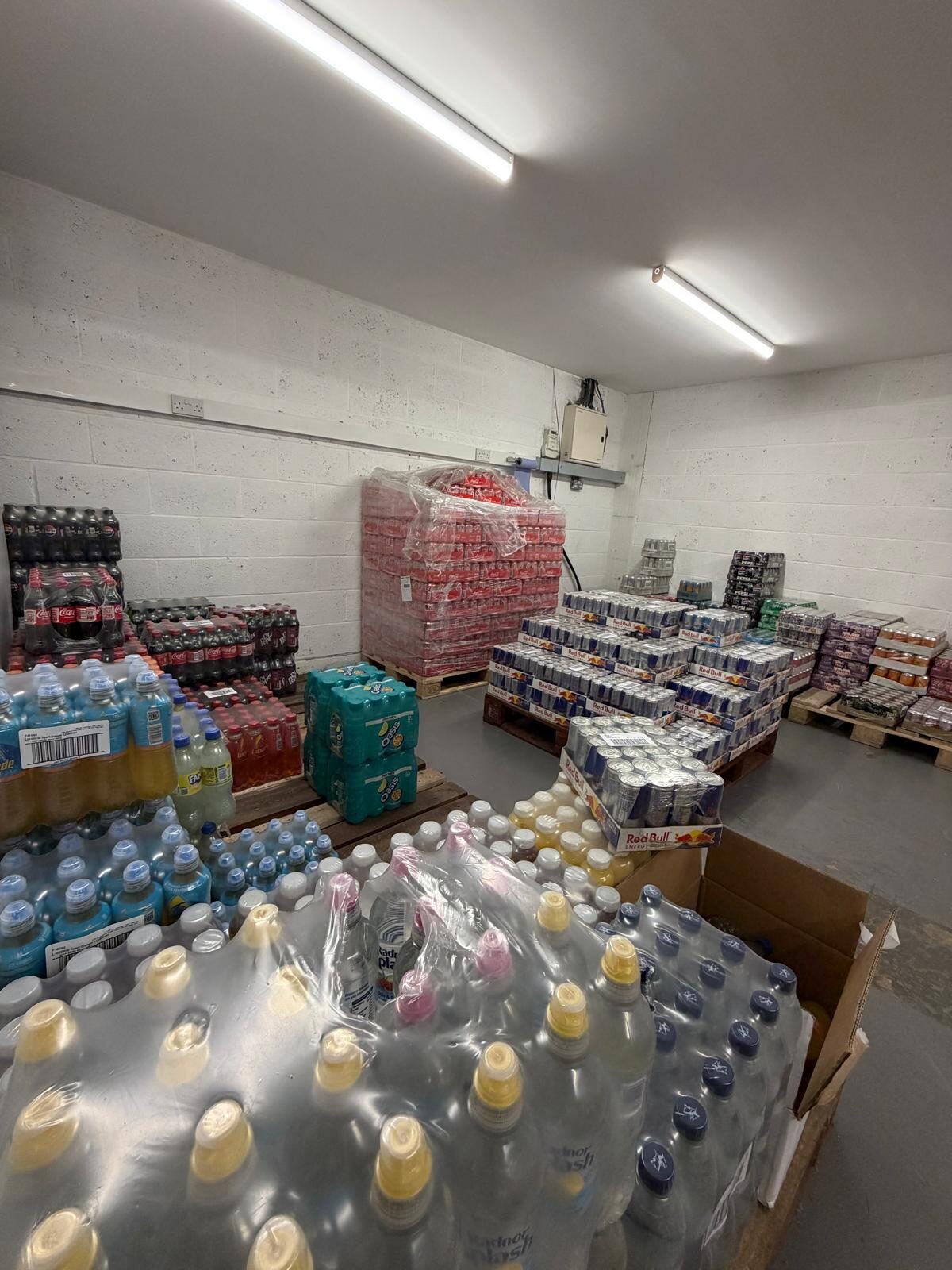 LC Vending Solutions wholesale warehouse — pallets of branded soft drinks, energy drinks and bottled water held in real stock.